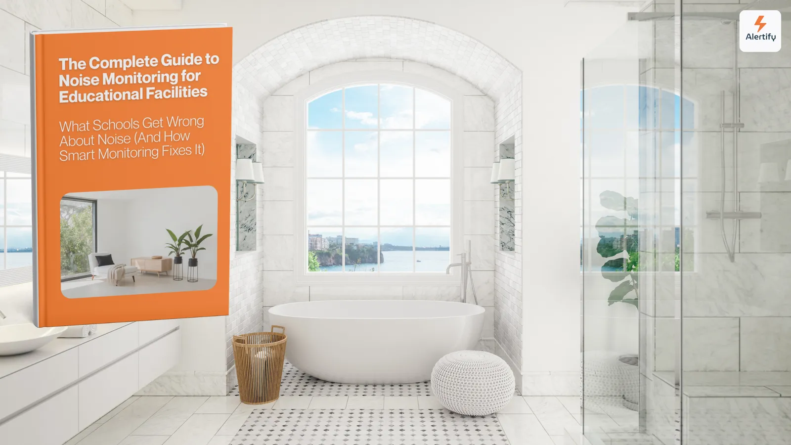Una guía de Alertify en forma de libro impreso, de pie sobre el tocador de un baño luminoso con azulejos de mármol, una bañera exenta y vistas al mar.